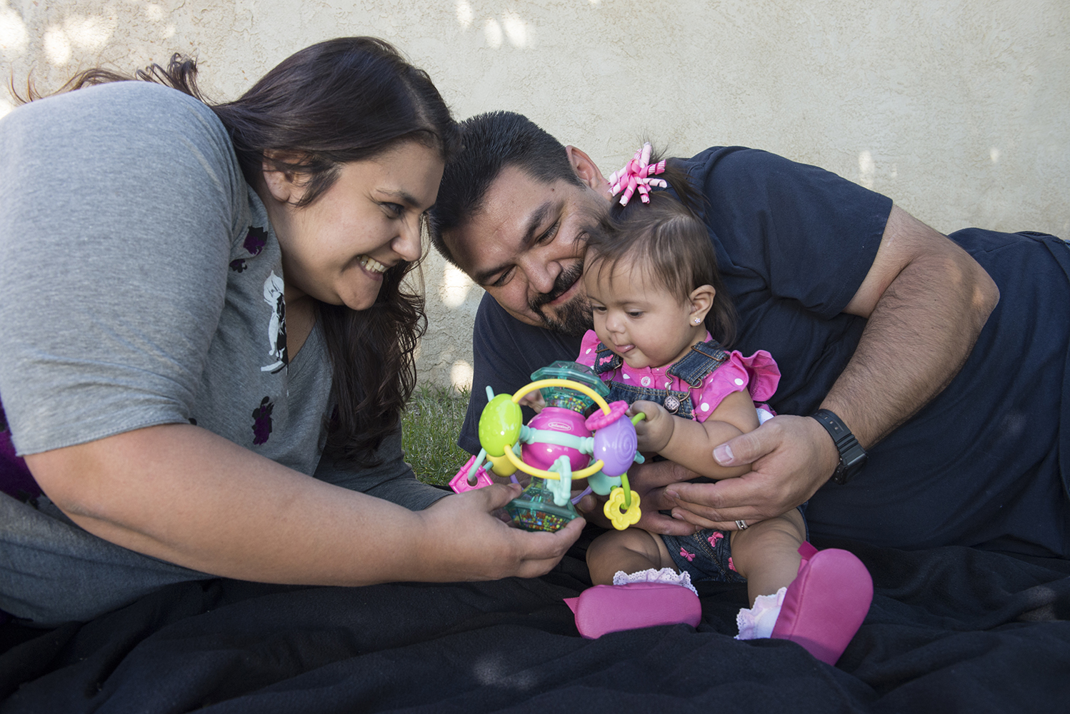 Mother and father playing with their infant daughter